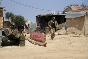 Fighters from a coalition of rebel groups called "Army of Fatah" walk near Psoncol town after saying they had taken control of it, in the Idlib countryside, Syria